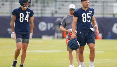 Jul 24, 2025; Lake Forest, IL, USA; Chicago Bears tight ends Colston Loveland (84) and Cole Kmet (85) stand on the field during training camp at Halas Hall.