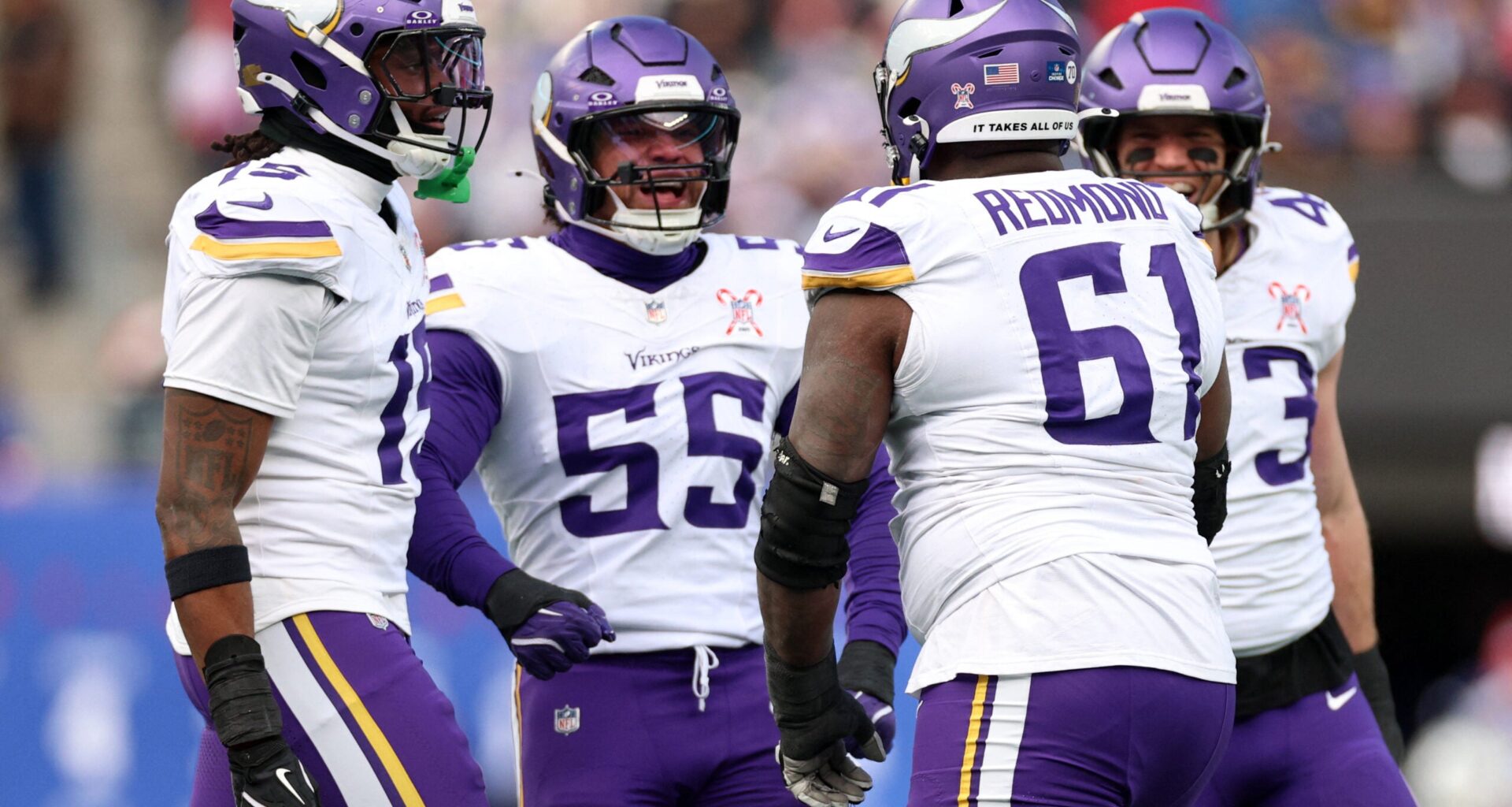 Dec 21, 2025; East Rutherford, New Jersey, USA; Minnesota Vikings defensive lineman Jalen Redmond (61) reacts with linebacker Eric Wilson (55) during the first half at MetLife Stadium.