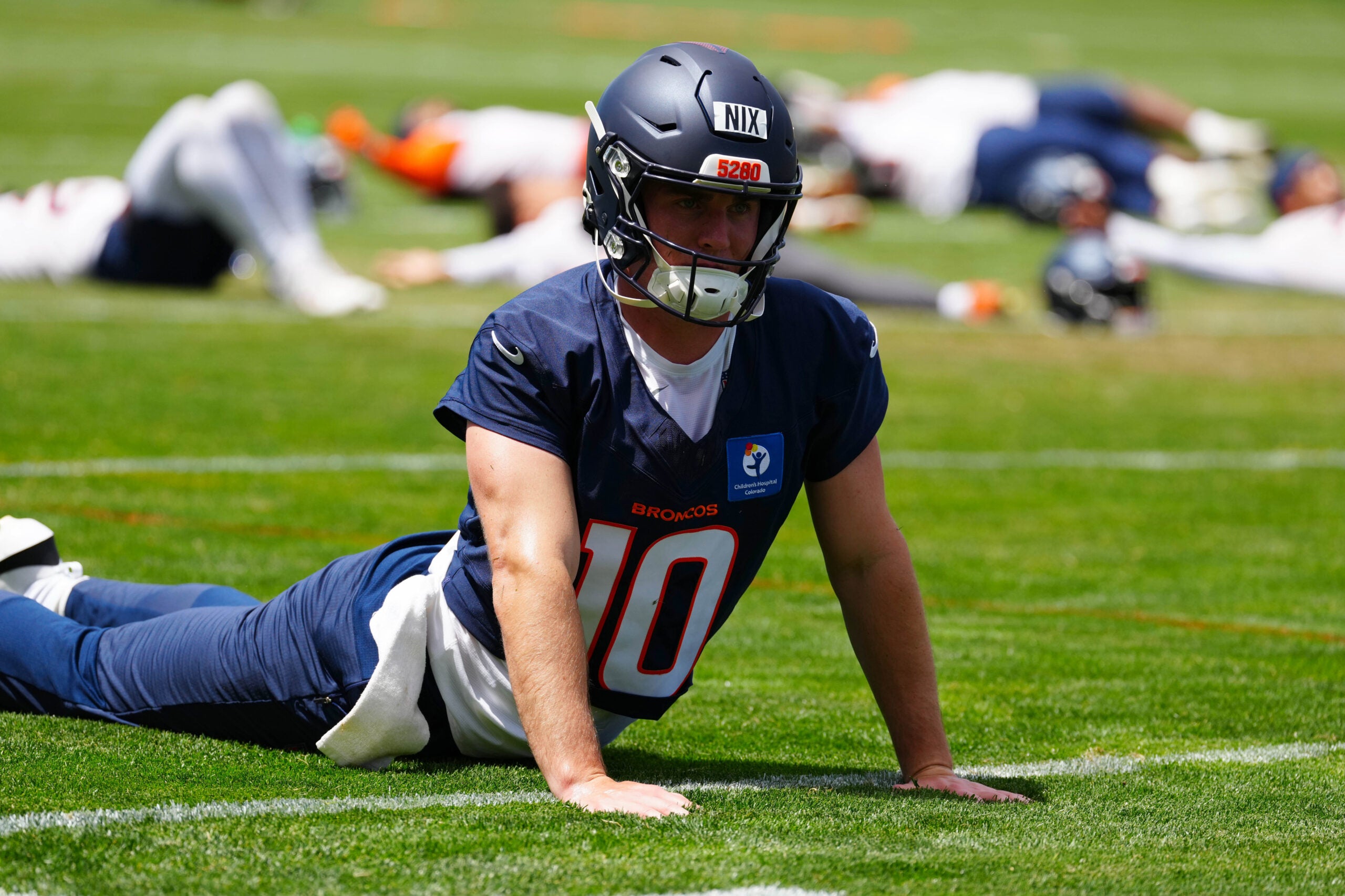 Jun 16, 2026; Englewood, CO, USA; Denver Broncos quarterback Bo Nix (10) warms up during mini camp at Broncos Park.