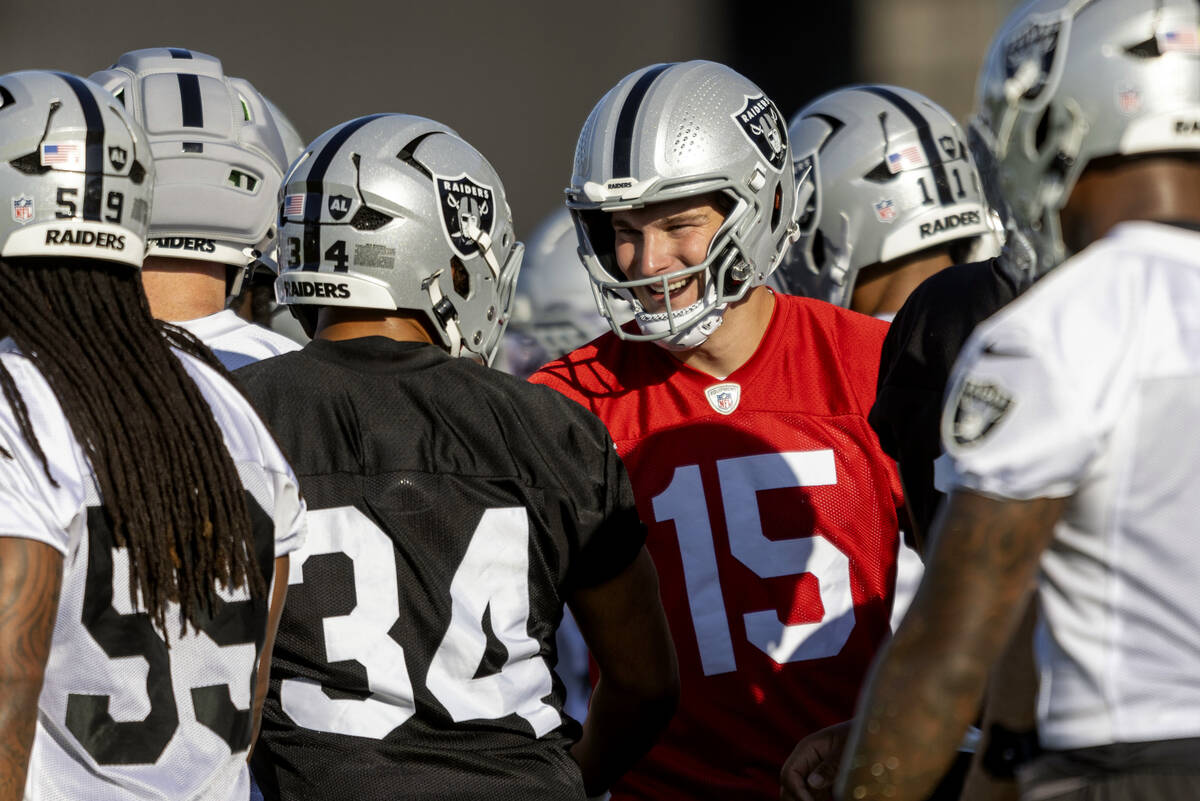 Raiders quarterback Fernando Mendoza (15) greets fullback Connor Heyward (34) during an NFL foo ...