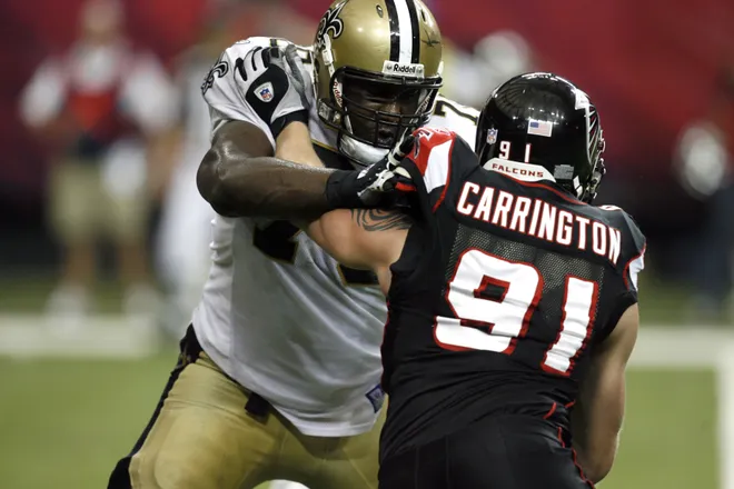 Nov 26, 2006; Atlanta, GA, USA; Atlanta Falcons defensive end (91) Paul Carrington tries to fight through a block by New Orleans Saints tackle (70) Jammal Brown in the fourth quarter at the Georgia Dome. The Saints defeated the Falcons 31 to 13. Mandatory Credit: Photo by Dale Zanine USA TODAY Sports Copyright (c) 2006 Dale Zanine