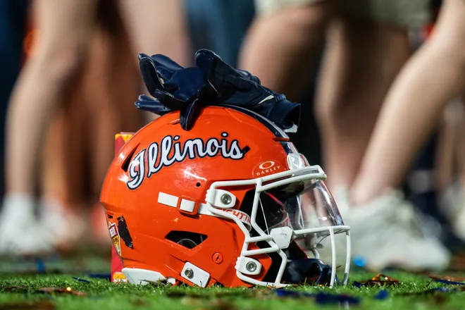Dec 31, 2024; Orlando, FL, USA; A Illinois Fighting Illini helmet sitting on confetti after the game against the South Carolina Gamecocks at Camping World Stadium. Mandatory Credit: Jeremy Reper-Imagn Images
