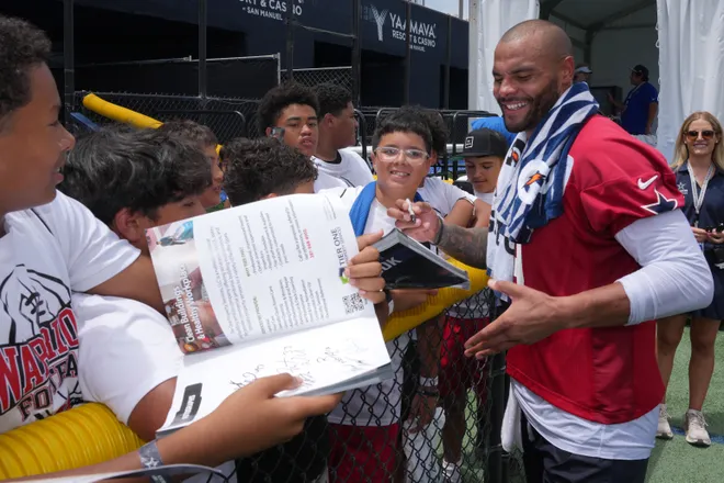 Jul 29, 2026; Oxnard, CA, USA; Dallas Cowboys quarterback Dak Prescott (4) signs autographs at training camp at River Ridge Playing Fields. Mandatory Credit: Kirby Lee-Imagn Images