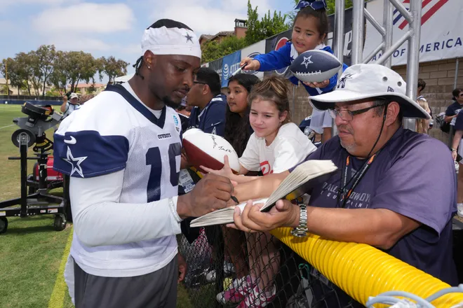 Jul 29, 2026; Oxnard, CA, USA; Dallas Cowboys receiver Ryan Flournoy (19) signs autographs at training camp at River Ridge Playing Fields. Mandatory Credit: Kirby Lee-Imagn Images