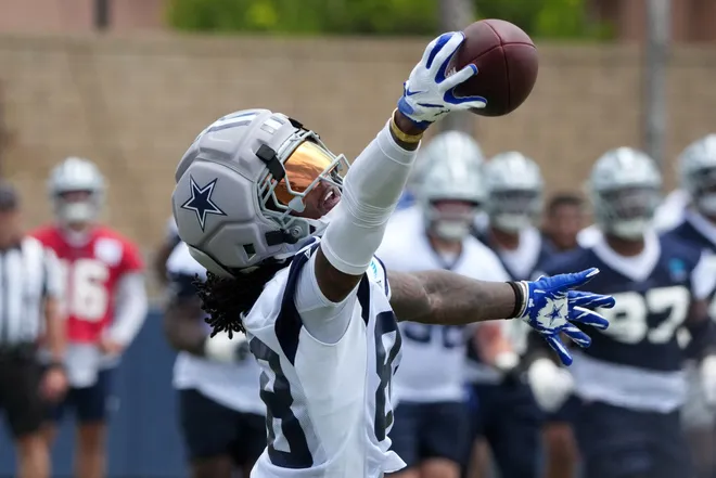 Jul 29, 2026; Oxnard, CA, USA; Dallas Cowboys receiver CeeDee Lamb (88) catches the ball wearing a Guardian helmet cap at training camp at River Ridge Playing Fields. Mandatory Credit: Kirby Lee-Imagn Images