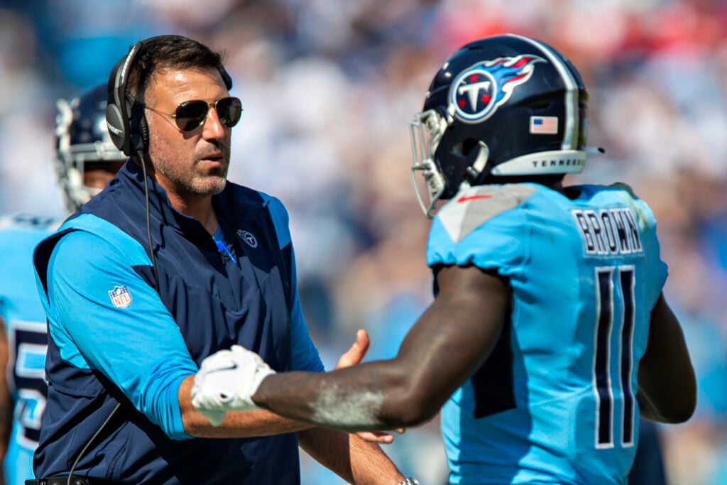 Head Coach Mike Vrabel greets A.J. Brown #11 of the Tennessee Titans as he comes off the field during a game against the Kansas City Chiefs at Nissan Stadium.
