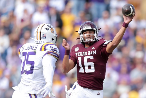 Jaylen Henderson #16 of the Texas A&M Aggies throws the ball as Sai'vion Jones #35 of the LSU Tigers defends during the first half at Tiger Stadium on November 25, 2023 in Baton Rouge, Louisiana. (Photo by Jonathan Bachman/Getty Images)