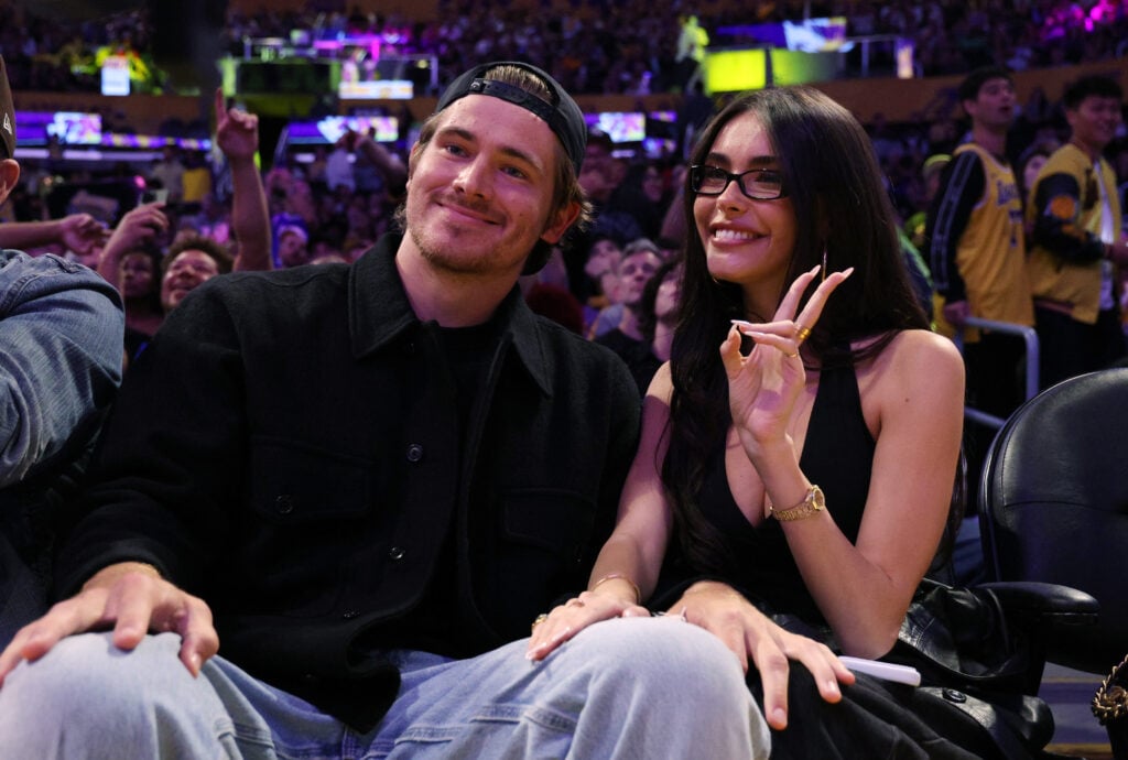 Quarterback Justin Herbert #10 of the Los Angeles Chargers and Madison Beer attend a basketball game between Los Angeles Lakers and Minnesota Timberwolves at Crypto.com Arena on October 24, 2025 in Los Angeles, California.