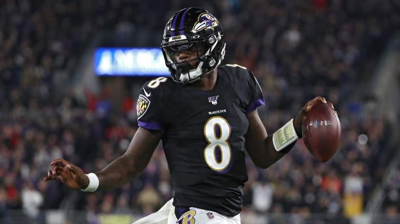 Quarterback Lamar Jackson #8 of the Baltimore Ravens scores a first quarter touchdown against the New England Patriots at M&T Bank Stadium on November 3, 2019 in Baltimore, Maryland