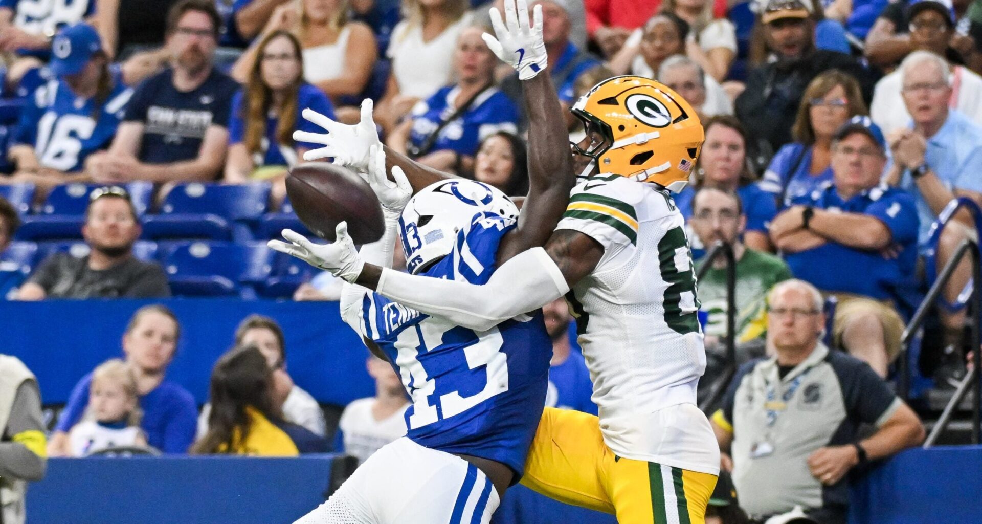 Aug 16, 2025; Indianapolis, Indiana, USA; Indianapolis Colts wide receiver Tyler Kahmann (43) breaks up a pass intended for Green Bay Packers wide receiver Isaiah Neyor (80) during the second half at Lucas Oil Stadium.