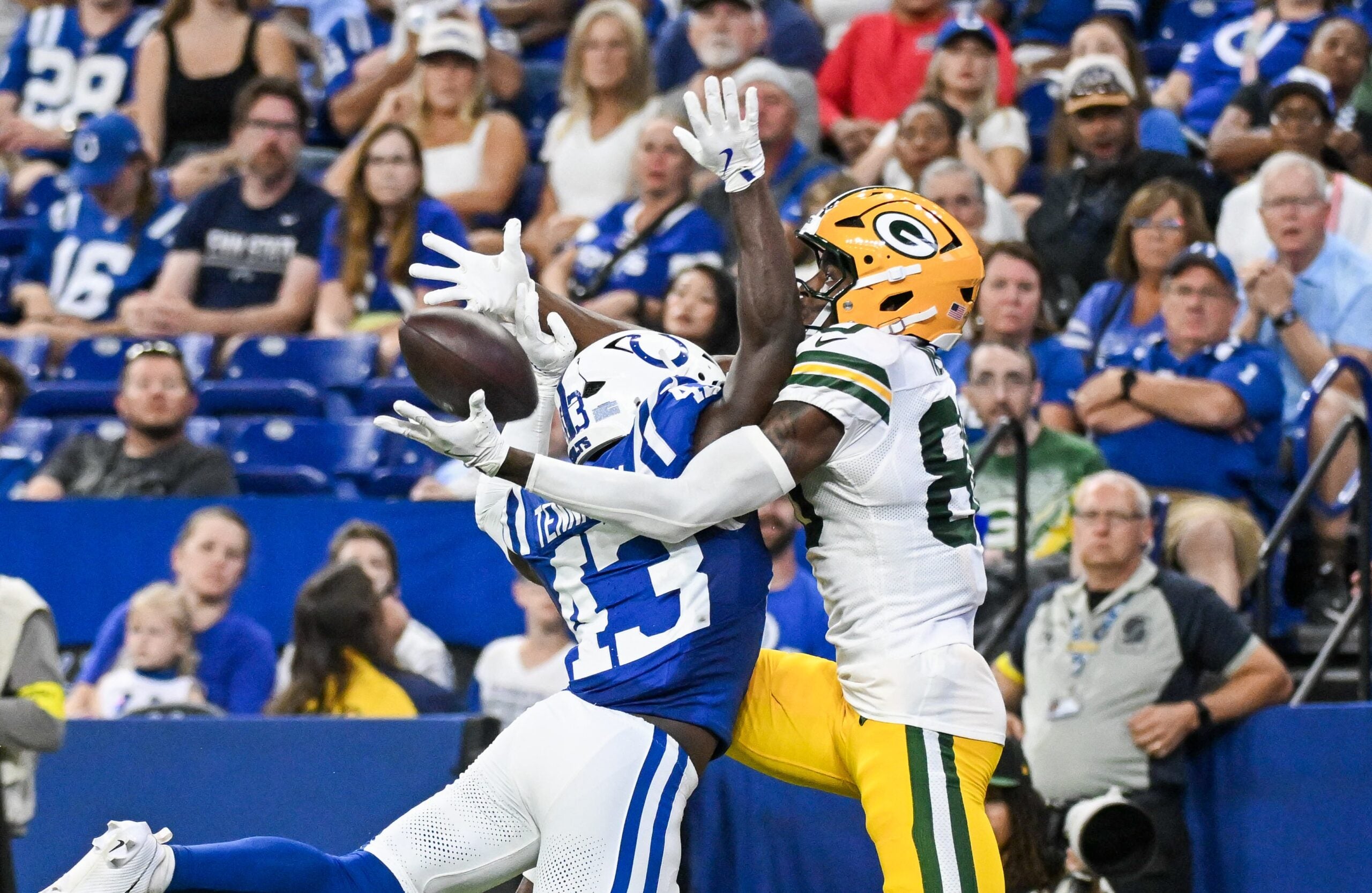 Aug 16, 2025; Indianapolis, Indiana, USA; Indianapolis Colts wide receiver Tyler Kahmann (43) breaks up a pass intended for Green Bay Packers wide receiver Isaiah Neyor (80) during the second half at Lucas Oil Stadium.