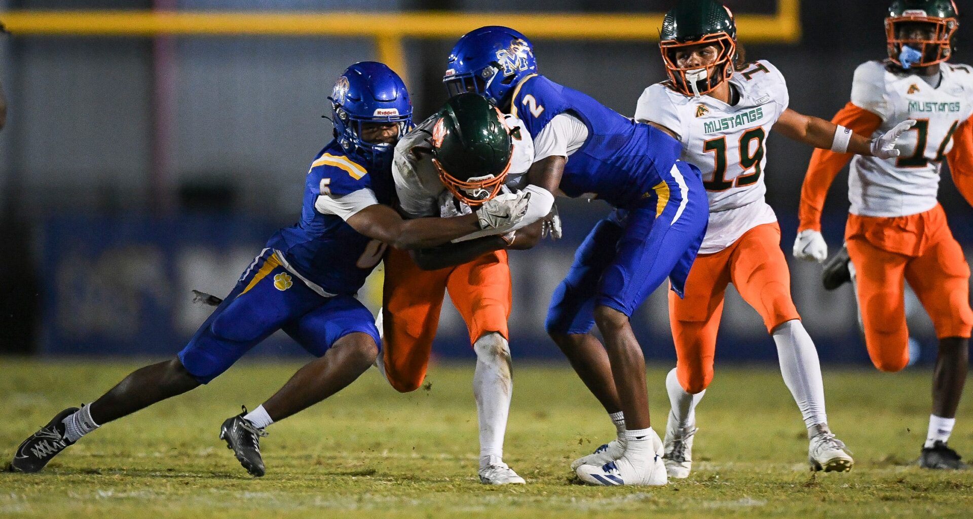 Martin County's Amarion Queen (2) and Jeromie King (5) tackle McArthur's Jaylyn Jones (4) in a Region 4-5A quarterfinal football game, Nov. 14, 2025, at Martin County High School. McArthur won 41-13.