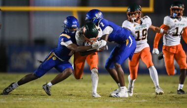 Martin County's Amarion Queen (2) and Jeromie King (5) tackle McArthur's Jaylyn Jones (4) in a Region 4-5A quarterfinal football game, Nov. 14, 2025, at Martin County High School. McArthur won 41-13.