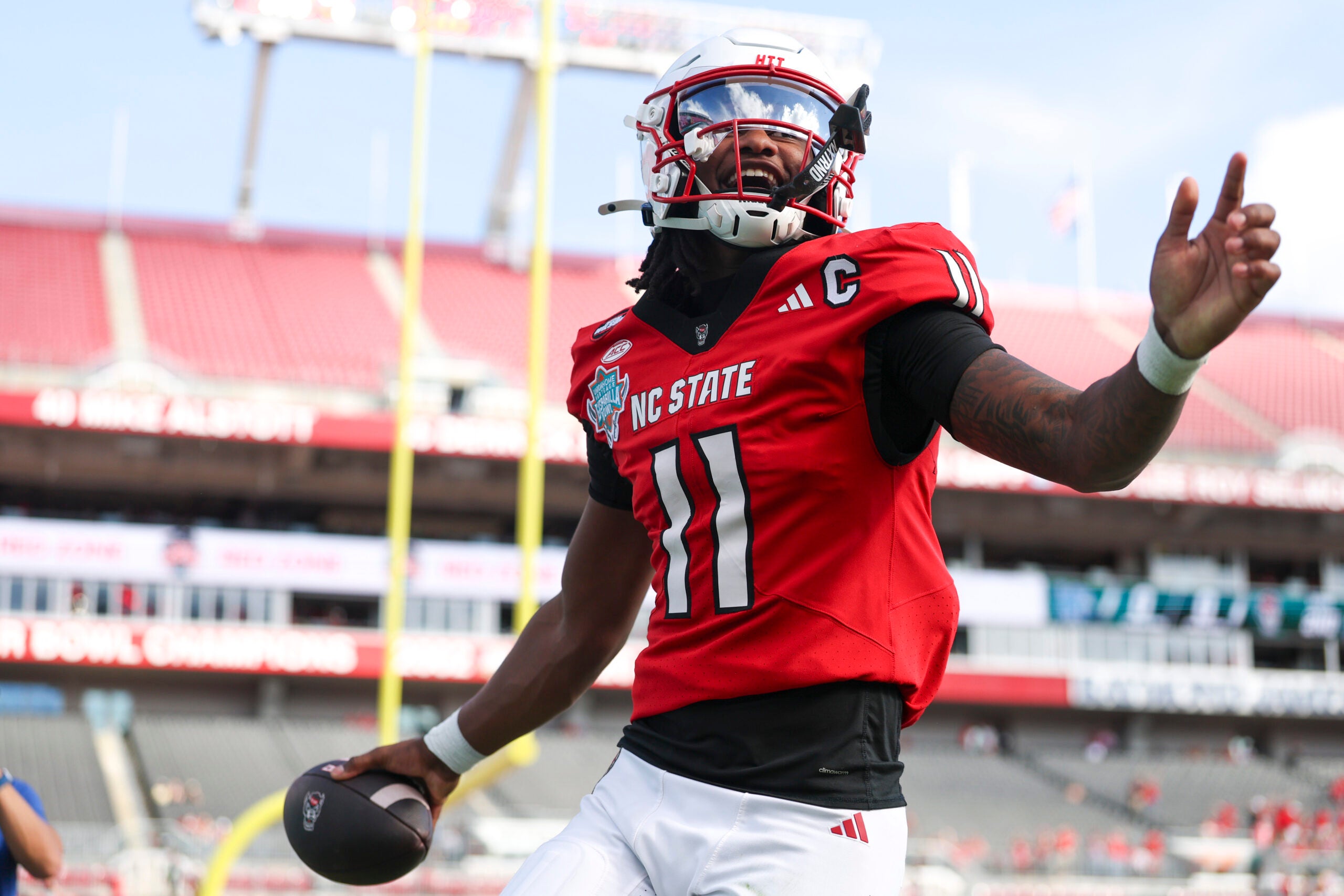 Dec 19, 2025; Tampa, FL, USA; NC State Wolfpack quarterback CJ Bailey (11) runs into the end zone for a touchdown against the Memphis Tigers in the first quarter during the Gasparilla Bowl at Raymond James Stadium.