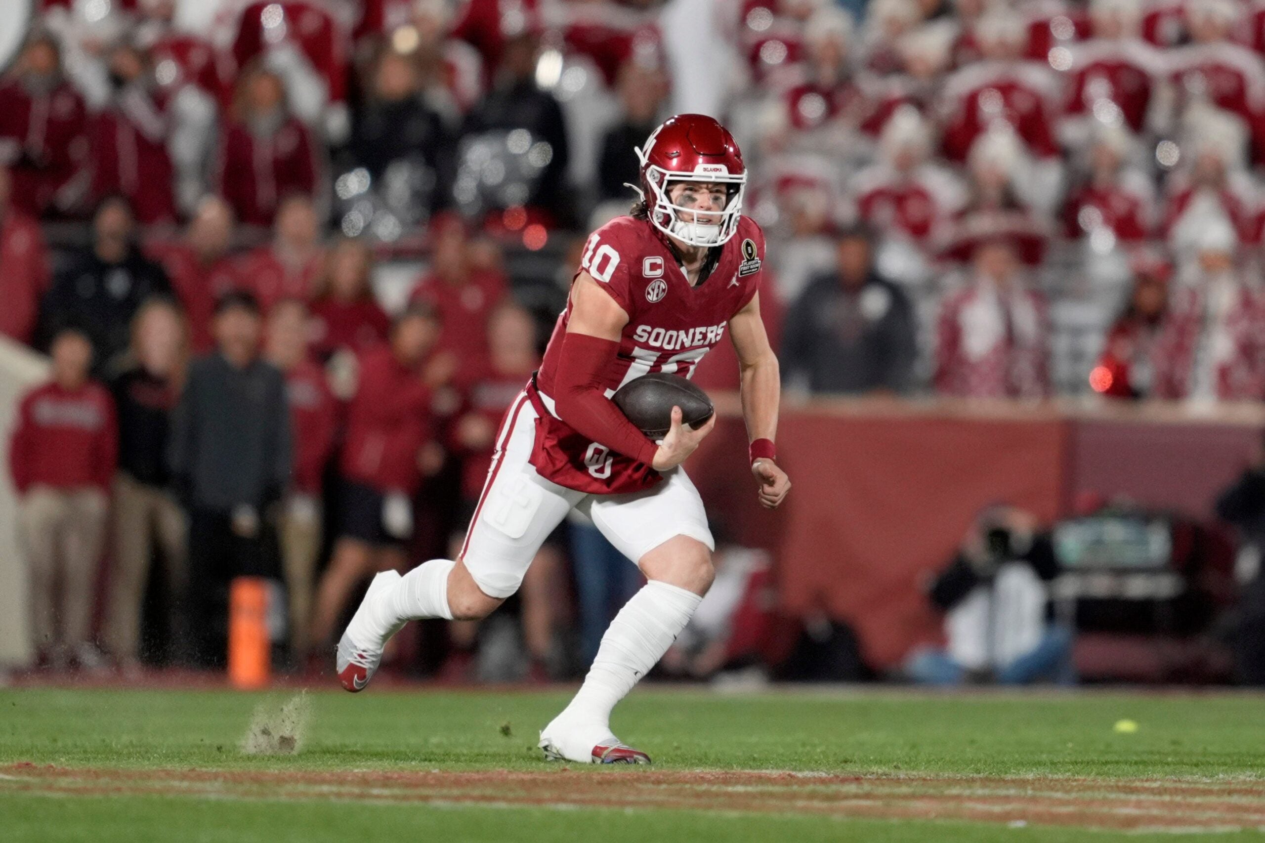 Oklahoma Sooners quarterback John Mateer (10) carries the ball during a first-round College Football Playoff game between the University of Oklahoma Sooners (OU) and the Alabama Crimson Tide at Gaylord Family - Oklahoma Memorial Stadium in Norman, Okla., Friday, Dec. 19, 2025. Alabama won 34-24.
