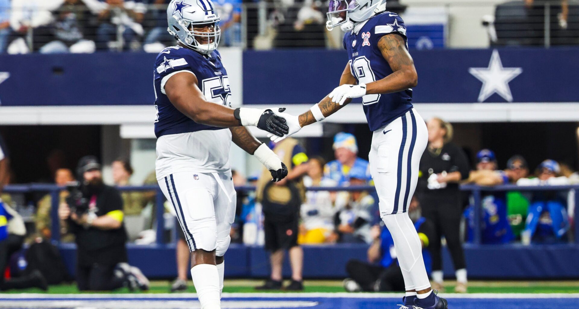 Dec 21, 2025; Arlington, Texas, USA; Dallas Cowboys wide receiver Ryan Flournoy (19) celebrates with guard Tyler Booker (52) after catching a touchdown pass against the Los Angeles Chargers during the first quarter at AT&T Stadium.