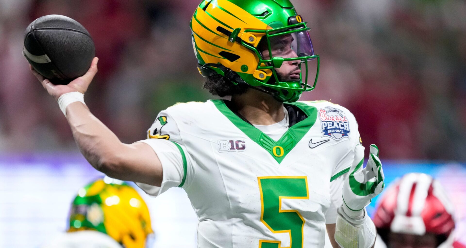Oregon Ducks quarterback Dante Moore (5) draws back to pass Friday, Jan. 9, 2026, during the Peach Bowl and semifinal game of the College Football Playoff against the Indiana Hoosiers at Mercedes-Benz Stadium in Atlanta.
