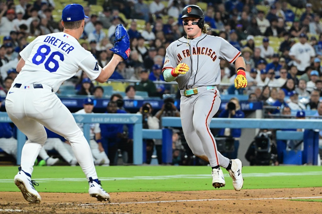 San Francisco Giants left fielder Harrison Bader (9) is caught in a rundown as Los Angeles Dodgers relief pitcher Jack Dreyer (86) is about to tag him out