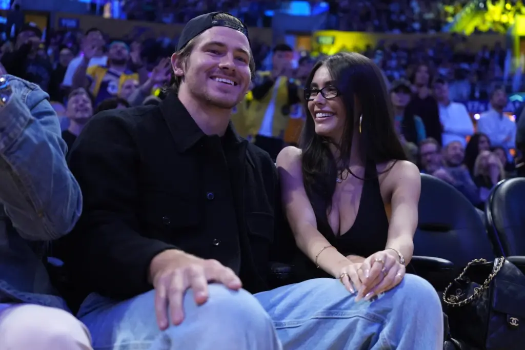 Oct 24, 2025; Los Angeles, California, USA; Los Angeles Chargers quarterback Justin Herbert (left) and girlfriend Madison Beer attend the game between the Minnesota Timberwolves and the Los Angeles Lakers at Crypto.com Arena. Mandatory Credit: Kirby Lee-Imagn Images