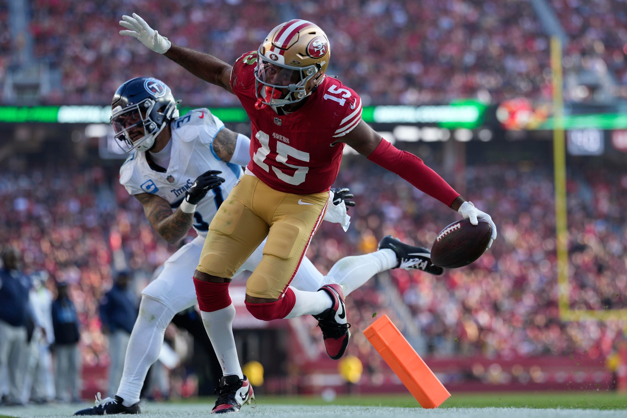 Dec 14, 2025; Santa Clara, California, USA; San Francisco 49ers wide receiver Jauan Jennings (15) scores a touchdown against Tennessee Titans safety Amani Hooker (37) during the third quarter at Levi’s Stadium. Mandatory Credit: Kyle Terada-Imagn Images