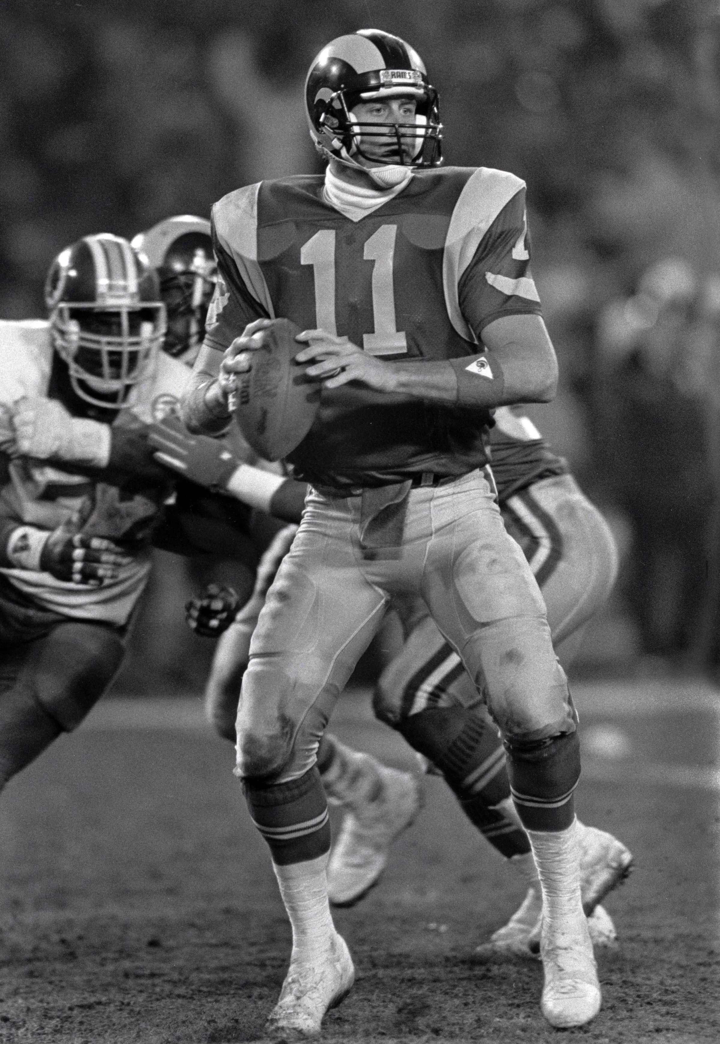Dec 28, 1986, Washington, D.C, USA; FILE PHOTO; Los Angeles Rams quarterback Jim Everett (11) looks to throw against the Washington Redskins During the 1986 NFC Wild Card Playoffs at RFK Stadium. The Redskins defeated the Rams 19-7. Mandatory Credit: RVR Photos-Imagn Images