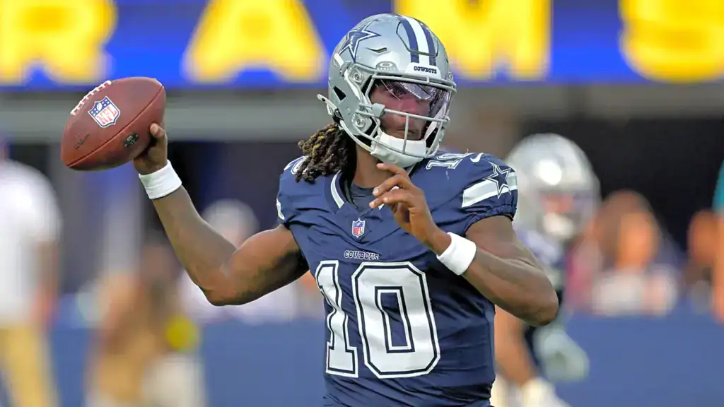 Joe Milton III throws a pass during Dallas Cowboys warmups in his navy No. 10 jersey.