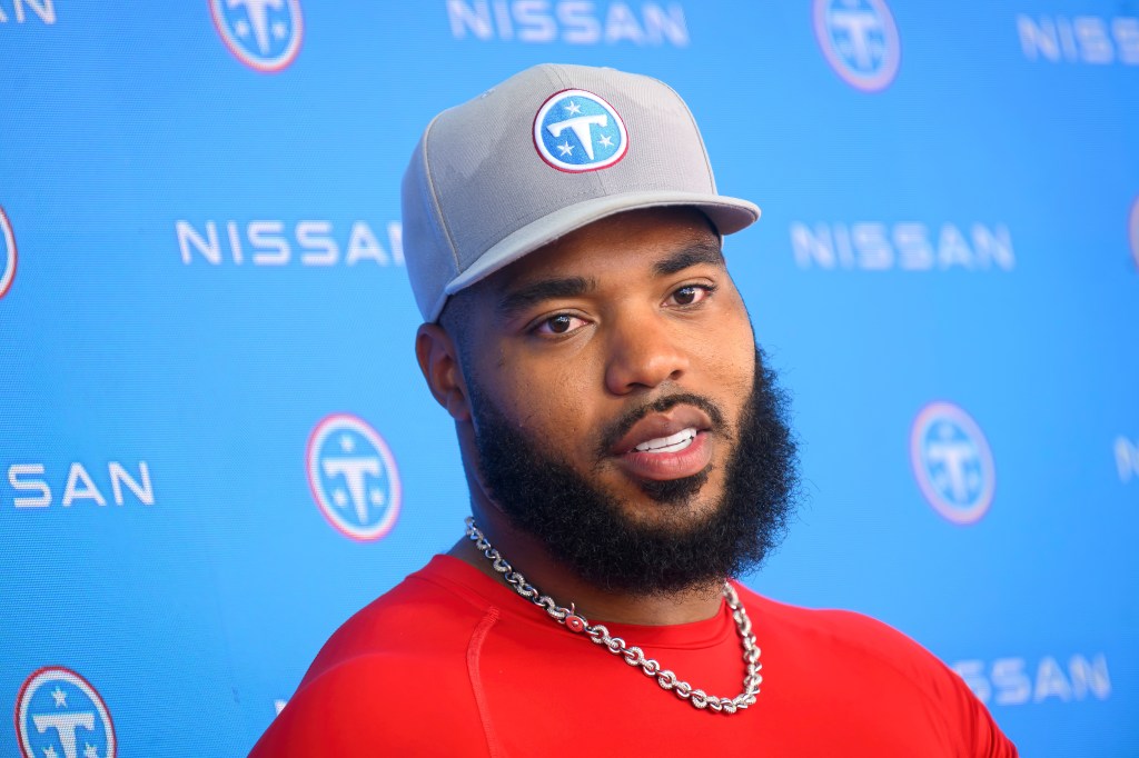 Tennessee Titans defensive tackle Jeffery Simmons in a grey hat and red shirt.