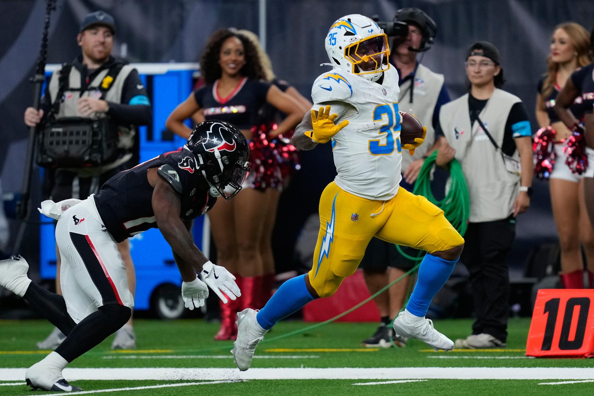 Chargers running back Amar Johnson runs past Houston Texans cornerback Brandon Codrington.