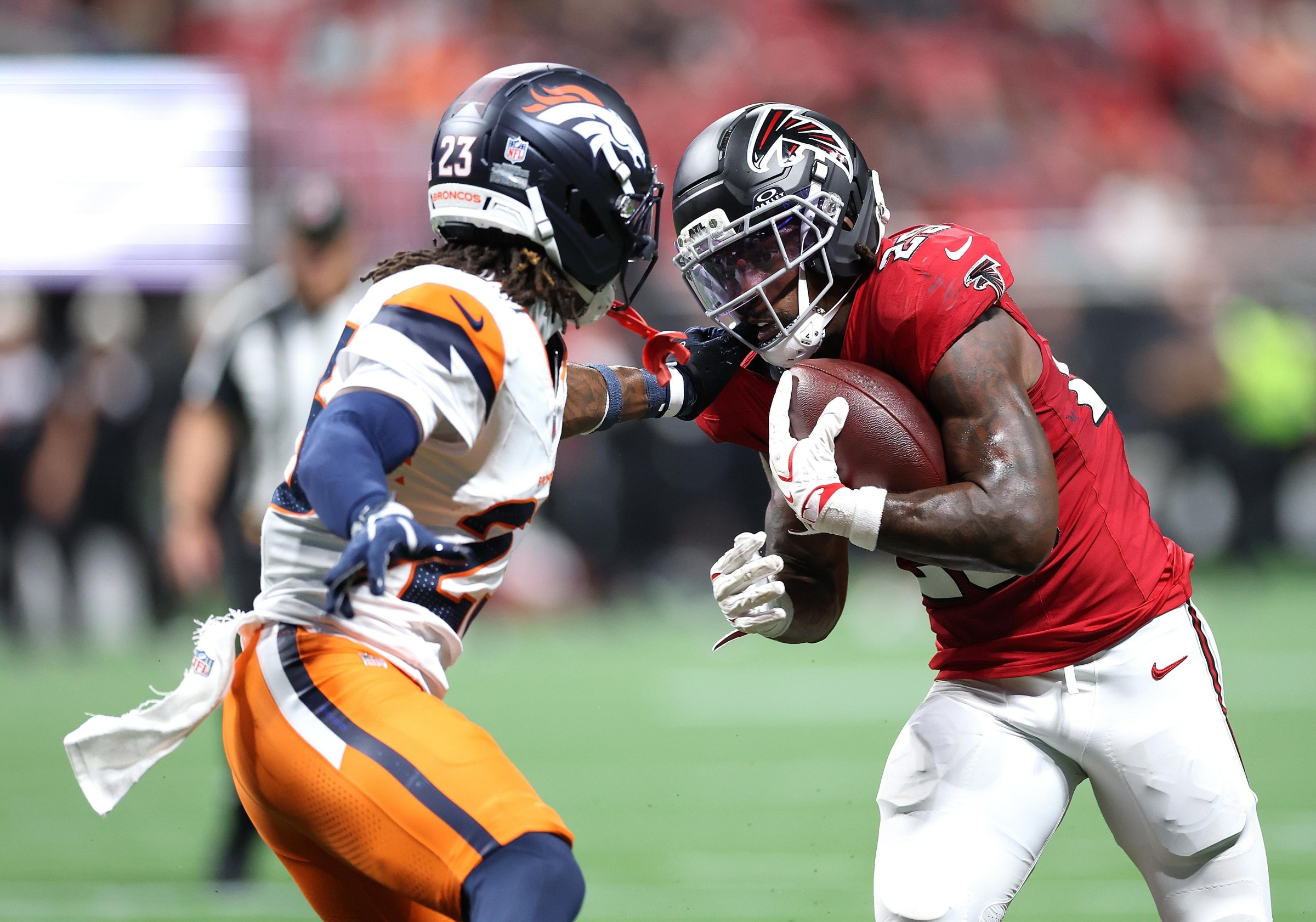 ATLANTA, GEORGIA - AUGUST 14: Tyler Goodson #25 of the Atlanta Falcons rushes against Jahdae Barron #23 of the Denver Broncos during the second quarter of a NFL preseason game at Mercedes-Benz Stadium on August 14, 2026 in Atlanta, Georgia. (Photo by Kevin C. Cox/Getty Images)