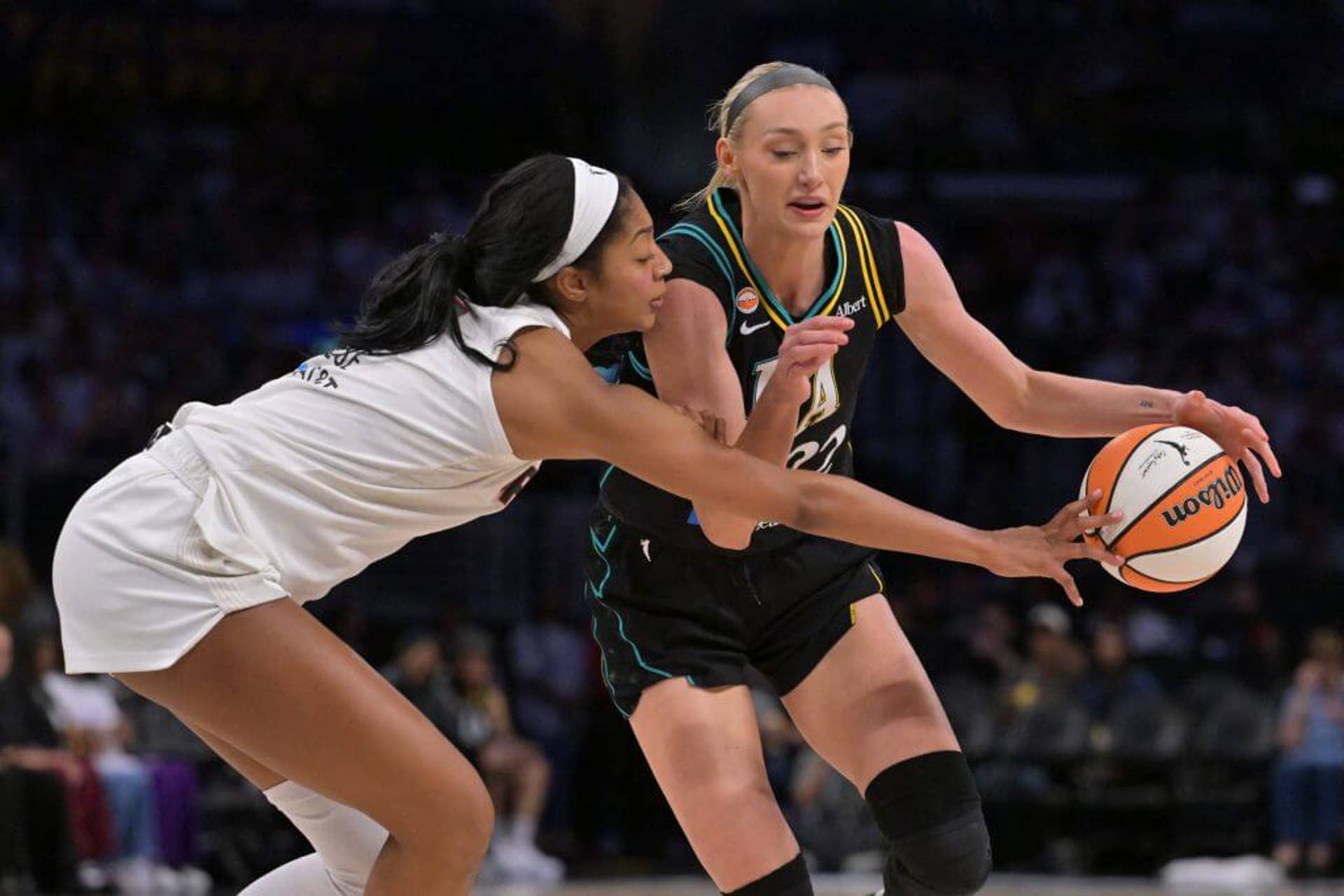Atlanta Dream forward Angel Reese, in a white uniform, plays defense against Cameron Brink of the Los Angeles Sparks on Aug. 20, 2026.