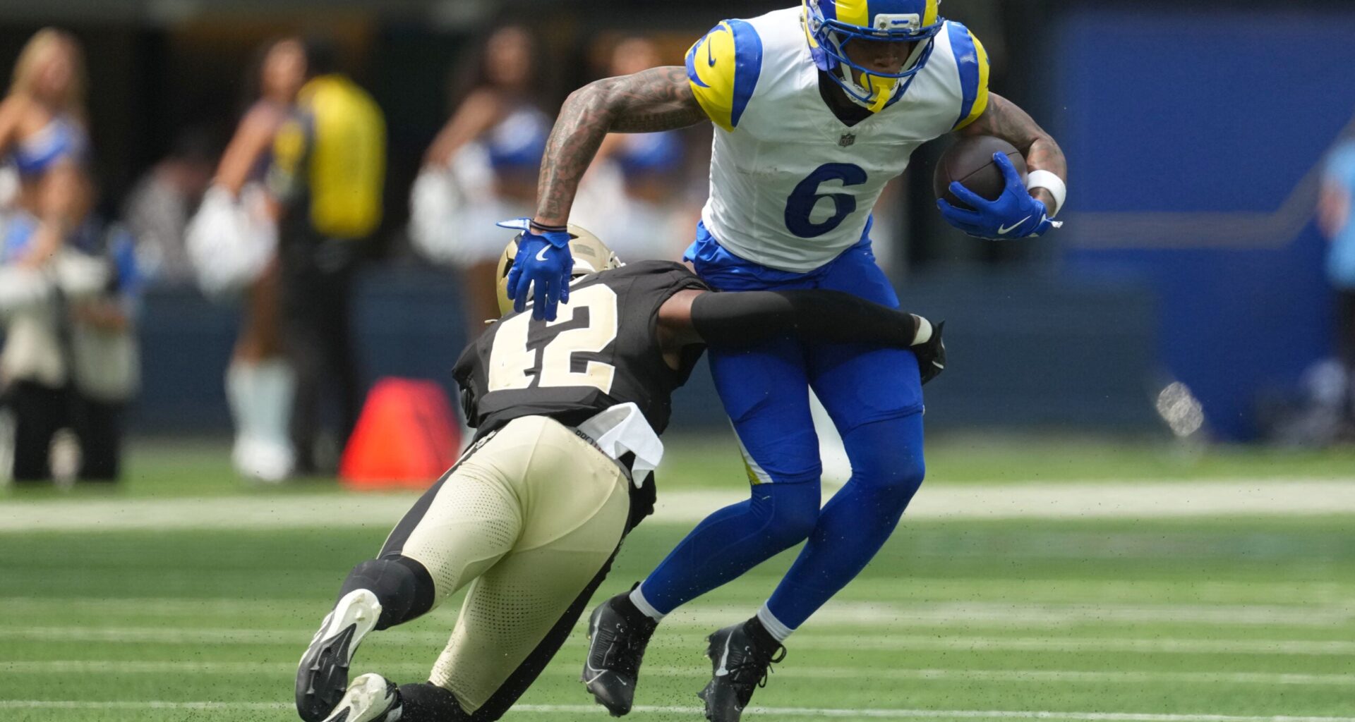 Aug 22, 2026; Inglewood, California, USA; Los Angeles Rams wide receiver CJ Daniels (6) carries the ball against 42 in the first half at SoFi Stadium.