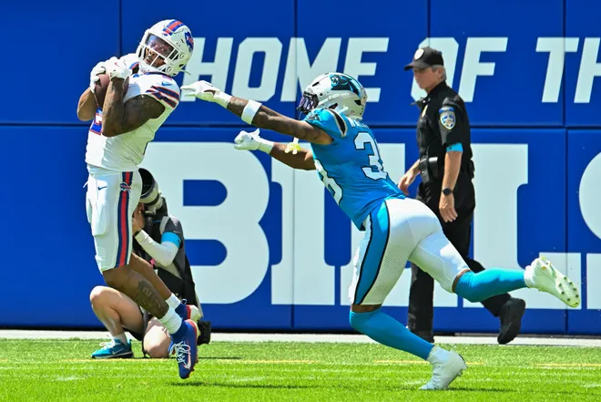 Aug 15, 2026; Orchard Park, New York, USA; Buffalo Bills wide receiver DJ Moore (2) tries to avoid a tackle by Carolina Panthers defensive back Zakee Wheatley (38) after making a catch in the first quarter at the New Highmark Stadium. Mandatory Credit: Mark Konezny-Imagn Images