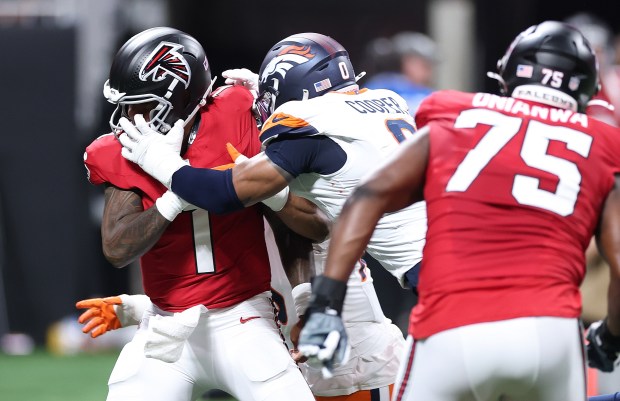 Tua Tagovailoa of the Atlanta Falcons is pressured by Jonathon Cooper #0 and Nik Bonitto #15 of the Denver Broncos during the first quarter of a NFL preseason game at Mercedes-Benz Stadium on August 14, 2026 in Atlanta, Georgia. (Photo by Kevin C. Cox/Getty Images)