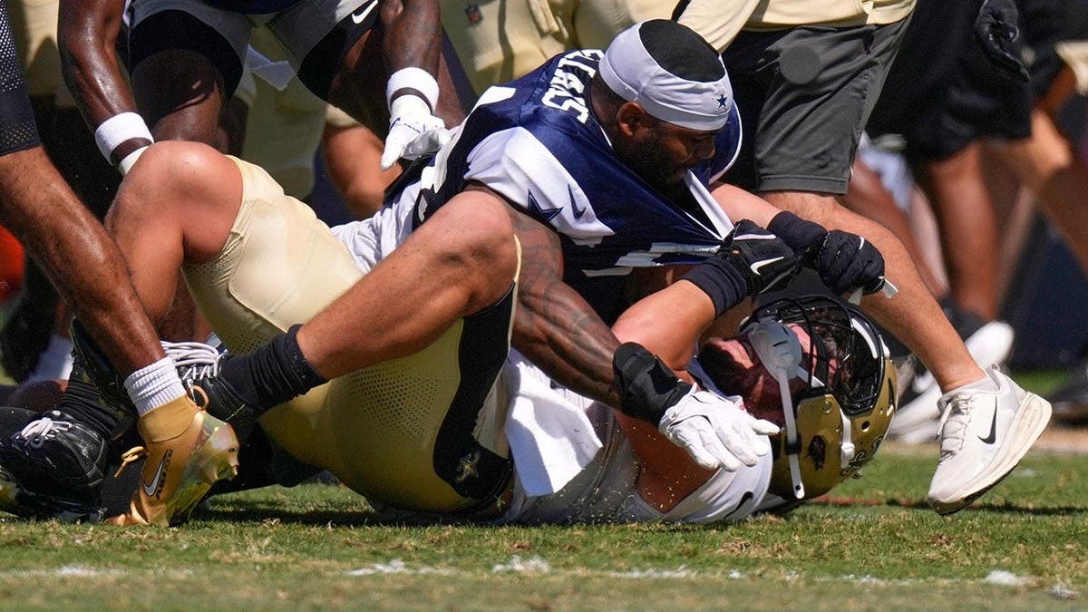 Dallas Cowboys outside linebacker Sam Williams, top, fight with New Orleans Saints tight end Moliki Matavao during an NFL football joint practice, Tuesday, Aug. 18, 2026, in Oxnard, Calif. Credit: Mark J. Terrill/AP Photo