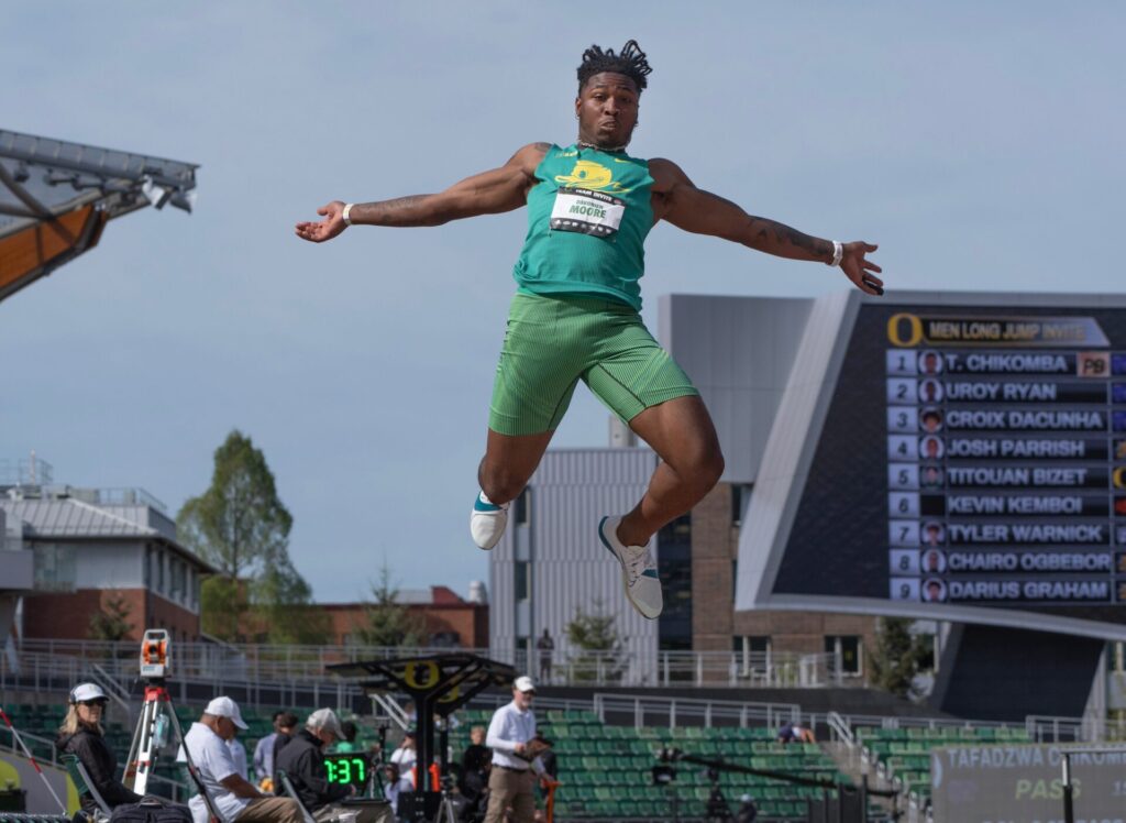 Oregon football wide receiver Dakorien Moore competes in the men's long jump during the Oregon Team Invitational track and field