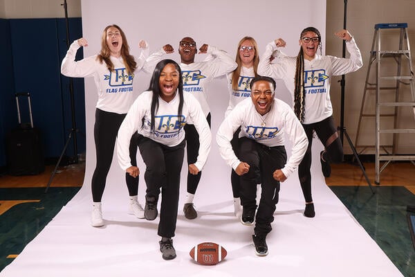 The Ursuline College Women's Flag Football team poses for a team picture in the studio.