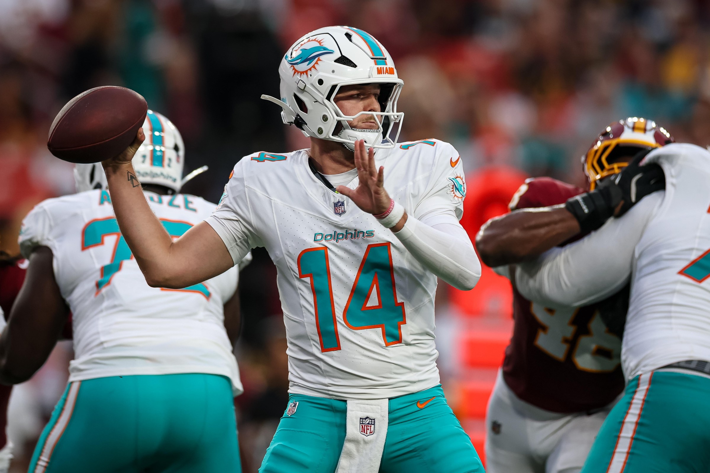 LANDOVER, MD - AUGUST 14: Quinn Ewers #14 of the Miami Dolphins attempts a pass against the Washington Commanders during the first half of the preseason game at Northwest Stadium on August 14, 2026 in Landover, Maryland. (Photo by Scott Taetsch/Getty Images)