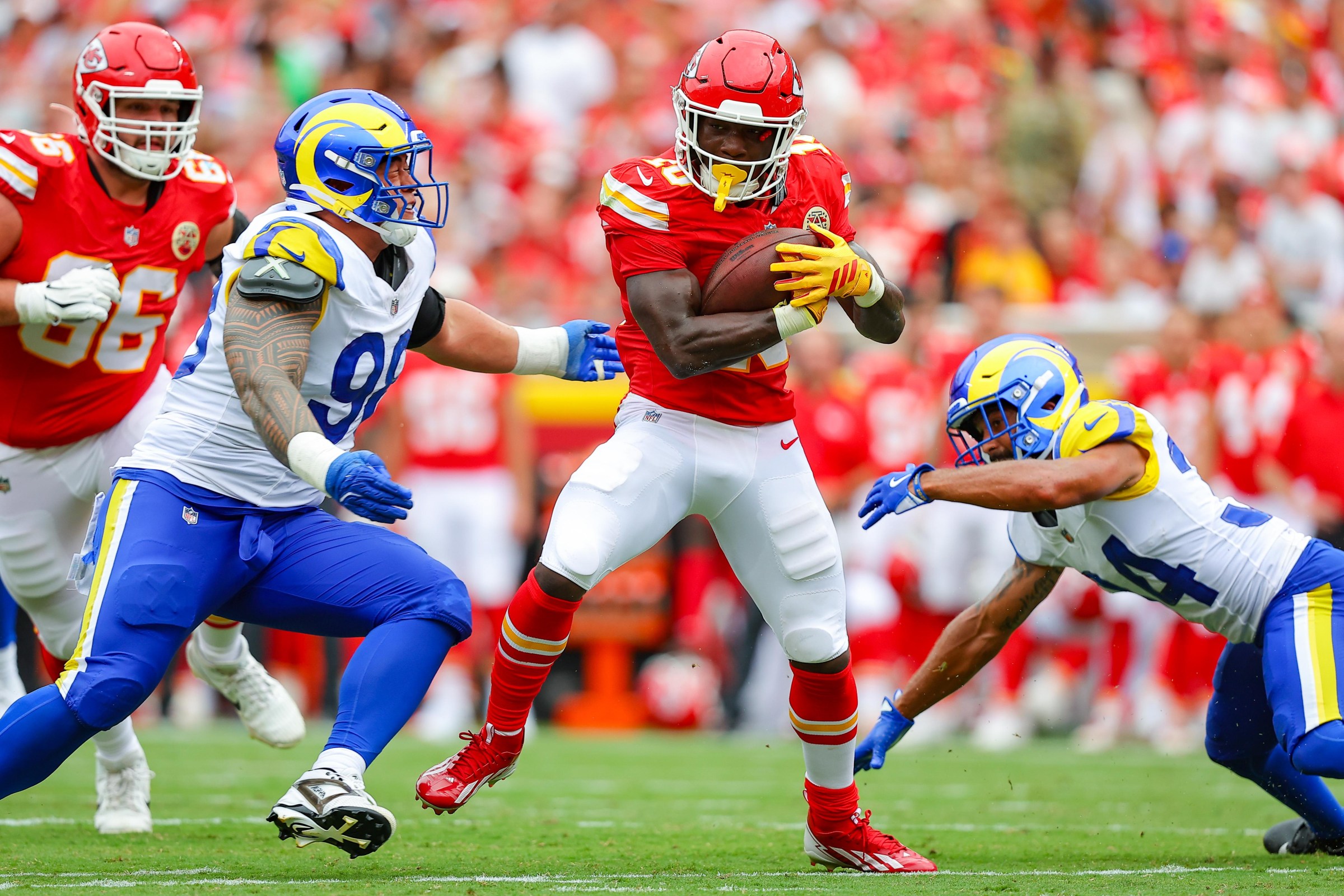 KANSAS CITY, MISSOURI - AUGUST 15: Running back Emmett Johnson #10 of the Kansas City Chiefs runs with the football during the third quarter near defensive tackle Jaxson Moi #98 of the Los Angeles Rams in an NFL preseason game at Arrowhead Stadium on August 15, 2026 in Kansas City, Missouri. (Photo by David Eulitt/Getty Images)
