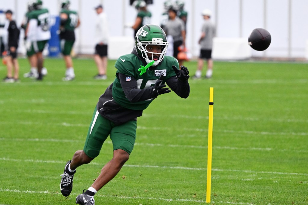 Jets wide receiver Isaiah Williams (18) catches a football at training camp.
