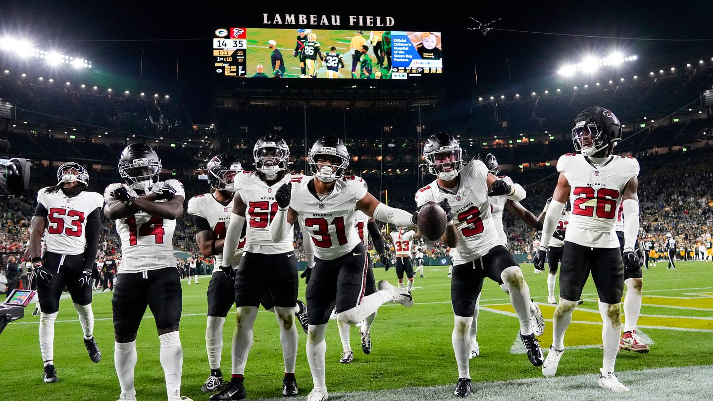 Sep 24, 2026; Green Bay, Wisconsin, USA;  The Atlanta Falcons defense celebrates following an interception during the fourth quarter against the Green Bay Packers at Lambeau Field. Mandatory Credit: Jeff Hanisch-Imagn Images