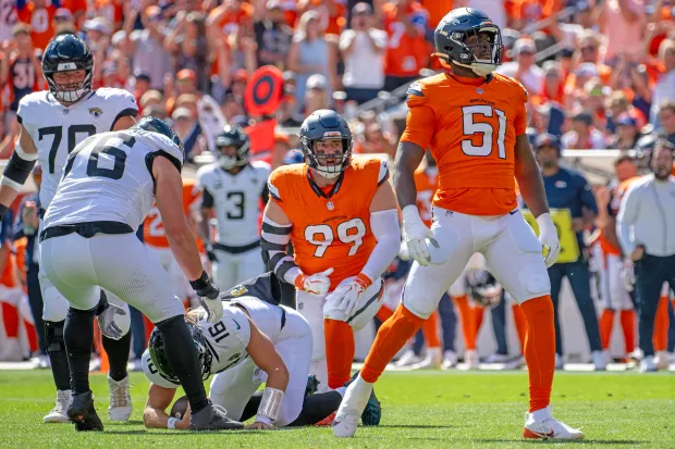 Denver Broncos line backer, Que Robinson (51) celebrates a sacking Jacksonville Jaguars quarterback, Trevor Lawrence (16) in the first half at Empower Field at Mile High in Denver on Sunday, Sept. 20, 2026. The Broncos defeated the Jaguars 20-13. (Michael G. Seamans, The Gazette)