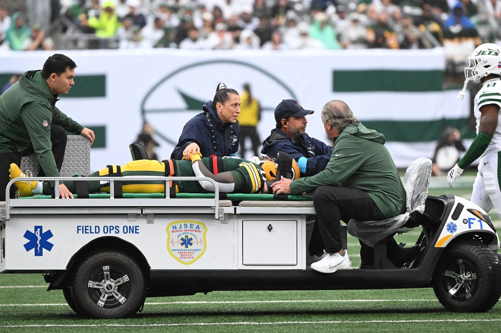 Green Bay Packers wide receiver Jayden Reed being removed from the field on a stretcher after being injured.