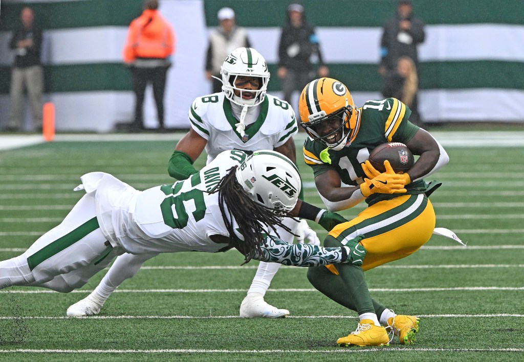 Green Bay Packers wide receiver Jayden Reed (11) is tackled by New York Jets linebacker Demario Davis (56) during the first quarter.