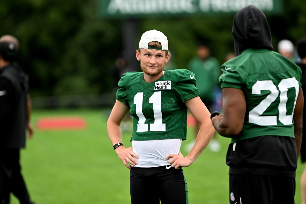 Jets kicker Blake Grupe (11) talks with running back Breece Hall (20) during practice.