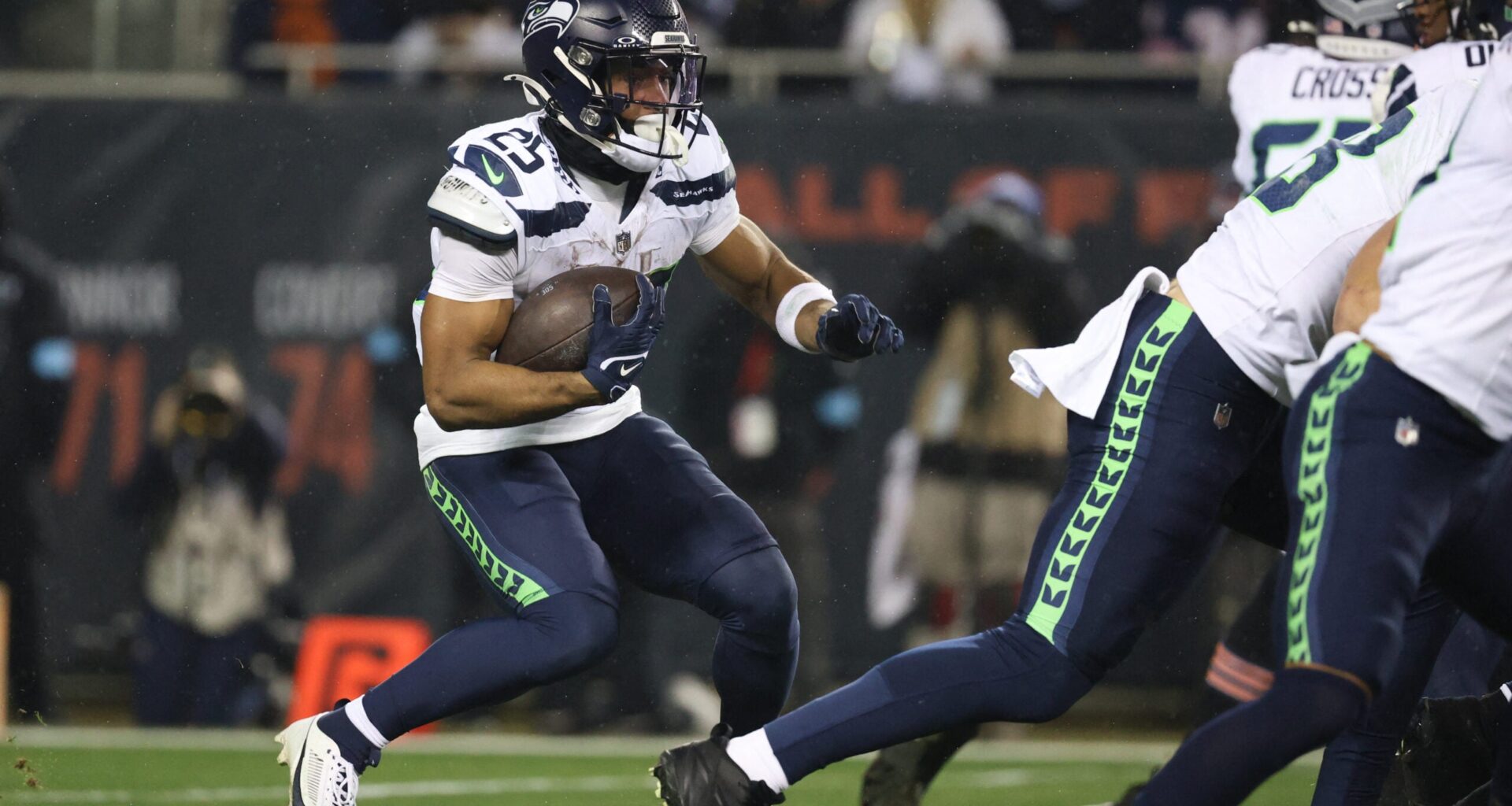 Dec 26, 2024; Chicago, Illinois, USA; Seattle Seahawks running back Kenny McIntosh (25) runs for a gain during the first quarter against the Chicago Bears at Soldier Field.