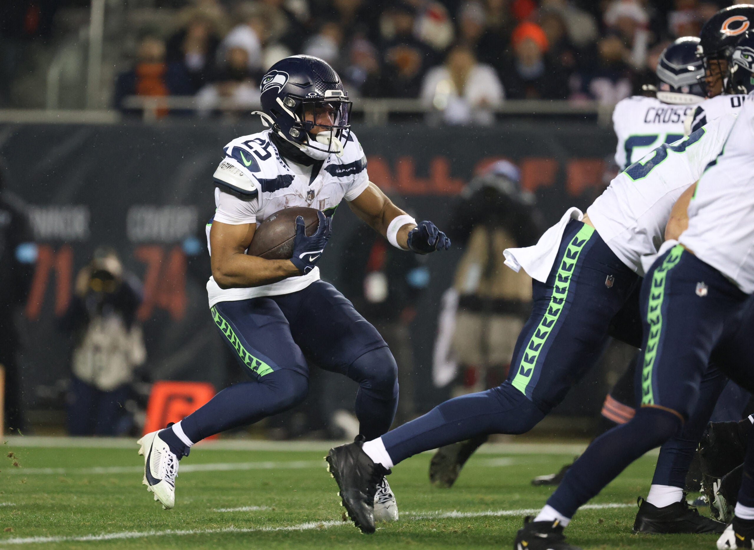 Dec 26, 2024; Chicago, Illinois, USA; Seattle Seahawks running back Kenny McIntosh (25) runs for a gain during the first quarter against the Chicago Bears at Soldier Field.