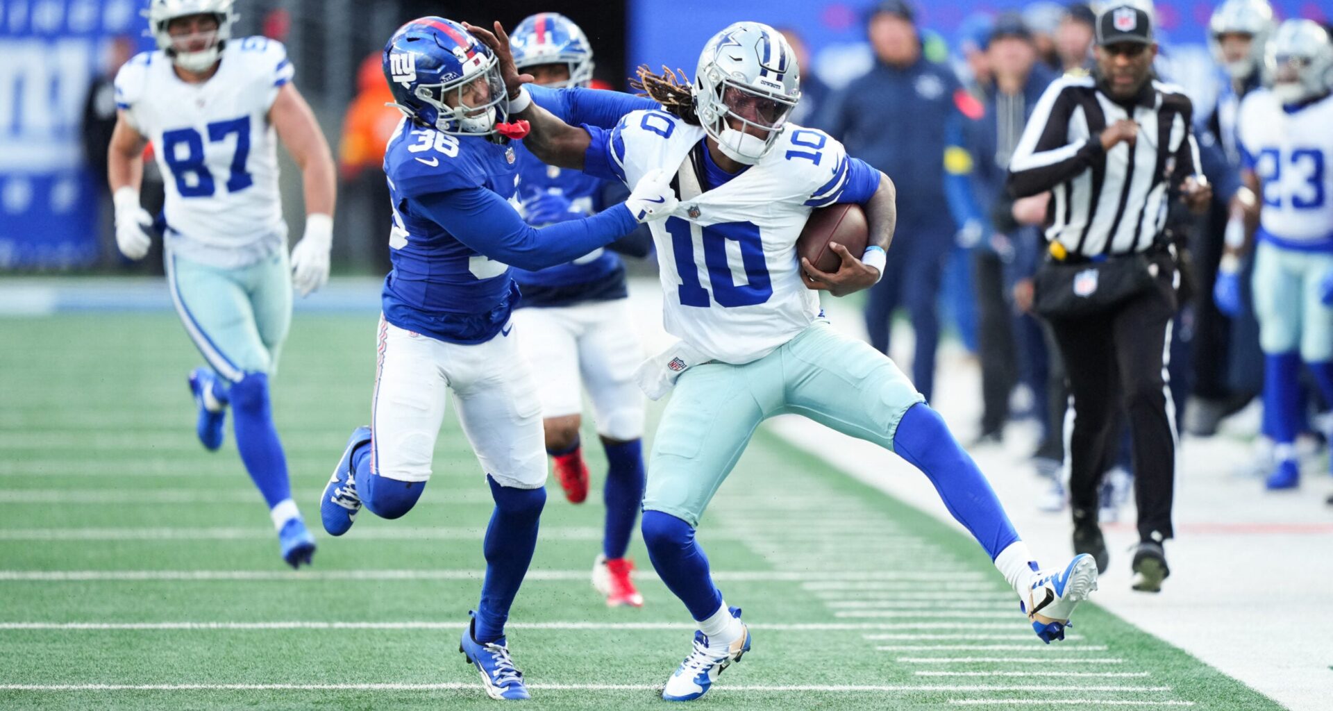 Jan 4, 2026; East Rutherford, New Jersey, USA; Dallas Cowboys quarterback Joe Milton III (10) scrambles and is tackled by New York Giants cornerback Rico Payton (36) during the fourth quarter at MetLife Stadium.