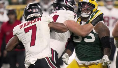 Green Bay Packers defensive tackle Chris McClellan (55) is blocked from tackling Atlanta Falcons running back Bijan Robinson (7) during the fourth quarter of their game Thursday, Sept. 24, 2026 at Lambeau Field in Green Bay, Wisconsin. The Atlanta Falcons beat there Green Bay Packers 35-14.