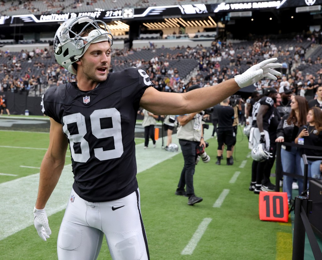 Brock Bowers of the Las Vegas Raiders waves to fans after warming up before a preseason game against the Arizona Cardinals at Allegiant Stadium in Las Vegas, Nevada, on Thursday, August 13, 2026.