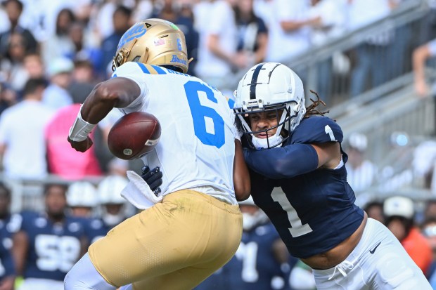 Penn State safety Jaylen Reed, right, forces a fumble by UCLA quarterback Justyn Martin during the third quarter of an NCAA college football game, Saturday, Oct. 5, 2024, in State College, Pa. (AP Photo/Barry Reeger)